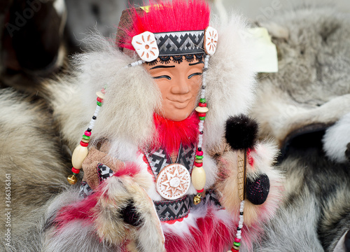 Figure of  shaman in national clothing made of fur with ornaments. Northern people. Eskimo.