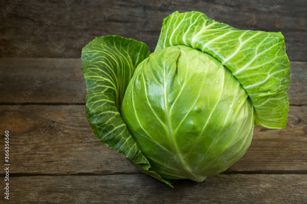 Fresh cabbage on an old wooden background