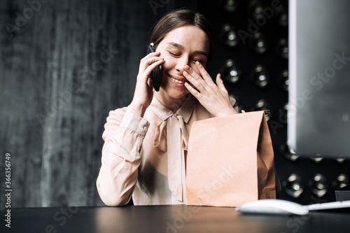 Fotografie Businesswoman in a beige blouse covers her eyes from overwhelming emotions and t