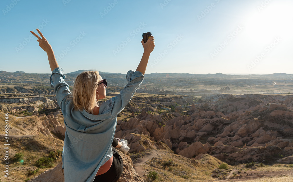 Woman enjoying coffee and sunset at beautiful valley. Digital detox concept Woman enjoying coffee and sunset at beautiful valley. Digital detox concept