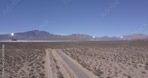 Aerial of Solar Power Plant in Nevada California Desert with Mountains in Horizon and Clear Blue Sky