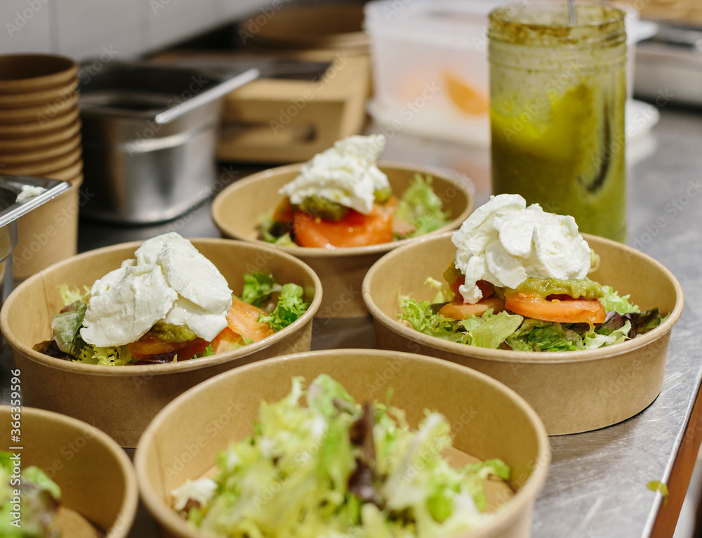 Preparing a endive and fresh cheese salad to take away. The containers used are compostable.