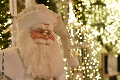 Close up of Santa mannequin with Christmas decorations, shallow focus.