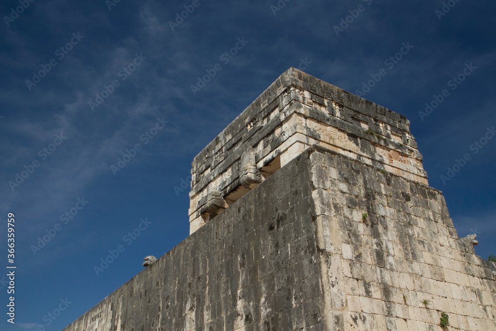 Travel. Ancient Maya culture and city ruins. Closeup of the stone building structure at the Great ball court in the Mayan city of Chichen Itza in Mexico. Travel. Ancient Maya culture and city ruins. Closeup of the stone building structure at the Great ball court in the Mayan city of Chichen Itza in Mexico.