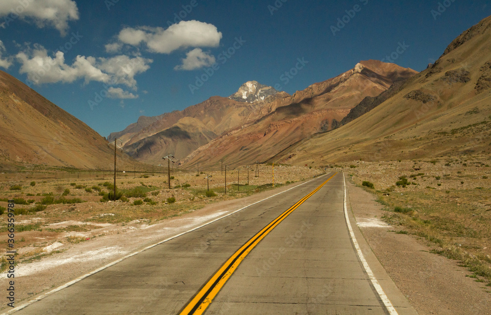 Naklejka premium Traveling. Getaway. Empty rural road across the valley and mountains. 