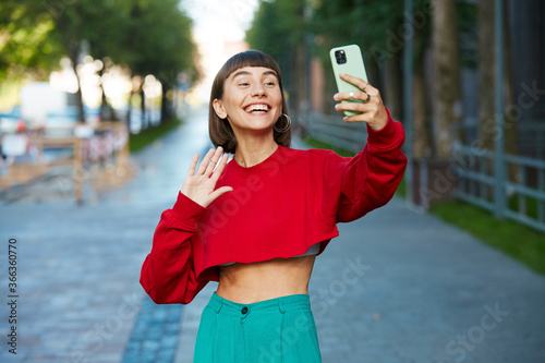 happy girl having video call on the street