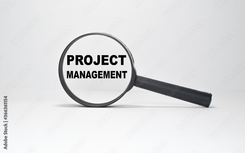 Magnifying glass with text Project Management on wooden table. Magnifying glass with text Project Management on wooden table.