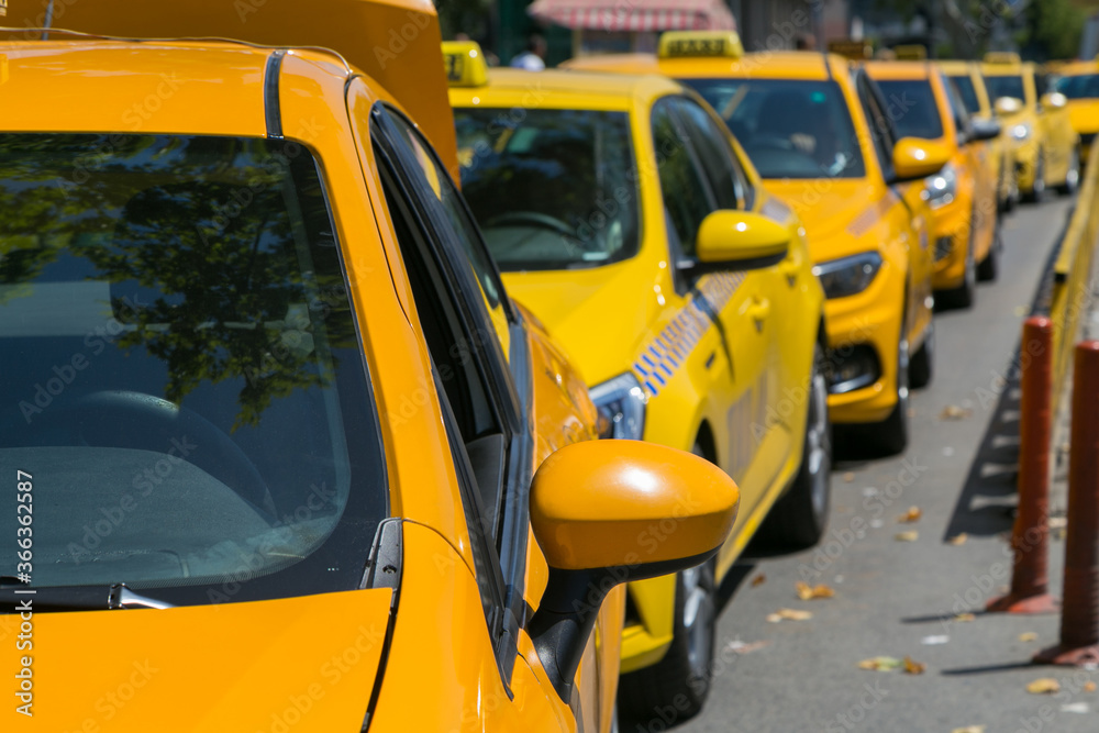 Yellow taxi cars on the empty street, taxi cab parking lot with yellow cars standing, set of taxicabs in the streets, taxis