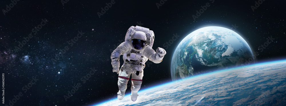 Astronaut in the space over the nightly planet Earth. Abstract wallpaper.  Spaceman. Elements of this image furnished by NASA Stock Photo