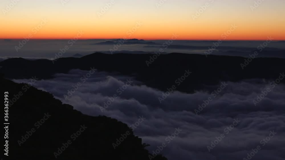 Majestic landscape covered with fog from the top of a mountain at sunset. Escaping in solitude into the wilderness. Stock video of connection to nature to the great outdoors. Majestic landscape covered with fog from the top of a mountain at sunset. Escaping in solitude into the wilderness. Stock video of connection to nature to the great outdoors.