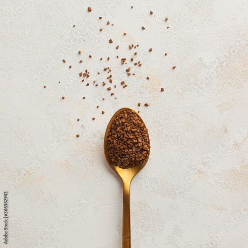 Instant coffee in a Golden spoon. Concept of instant coffee birthday celebration. Copy space. July 24