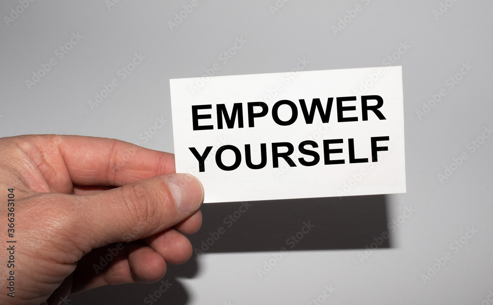 Message on the card EMPOWER YOURSELF, in hands of businessman. Message on the card EMPOWER YOURSELF, in hands of businessman.