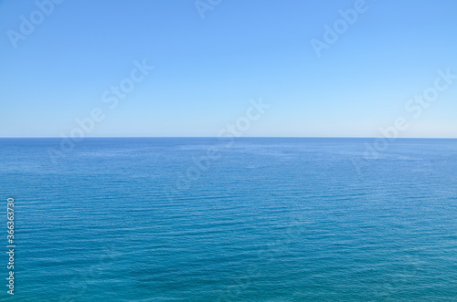 Calm deep sea with ripples on the surface and blue clear sky. Water natural background or texture  © Dmytro