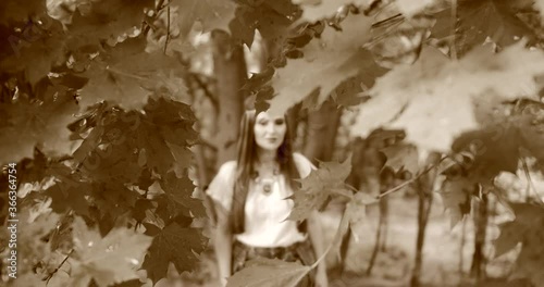 happy hippie girl walks among the trees. stylized film