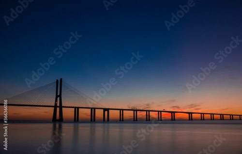 Beautiful sunrise at Vasco da Gama Bridge  the longest bridge in Europe  who spans the Tagus River in Lisbon  Portugal.