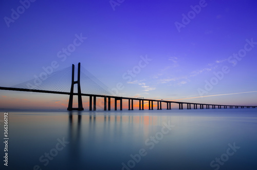 Beautiful sunrise at Vasco da Gama Bridge, the longest bridge in Europe, who spans the Tagus River in Lisbon, Portugal. © Aron M  - Austria