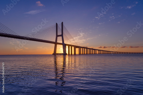 Sunrise at Vasco da Gama Bridge, the longest bridge in Europe, who spans the Tagus River, in Lisbon, Portugal.