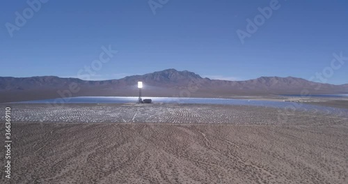 Aerial of Desert Solar Power Plant on Nevada California boarder with Mountains in Horizon and Clear Blue Sky 
