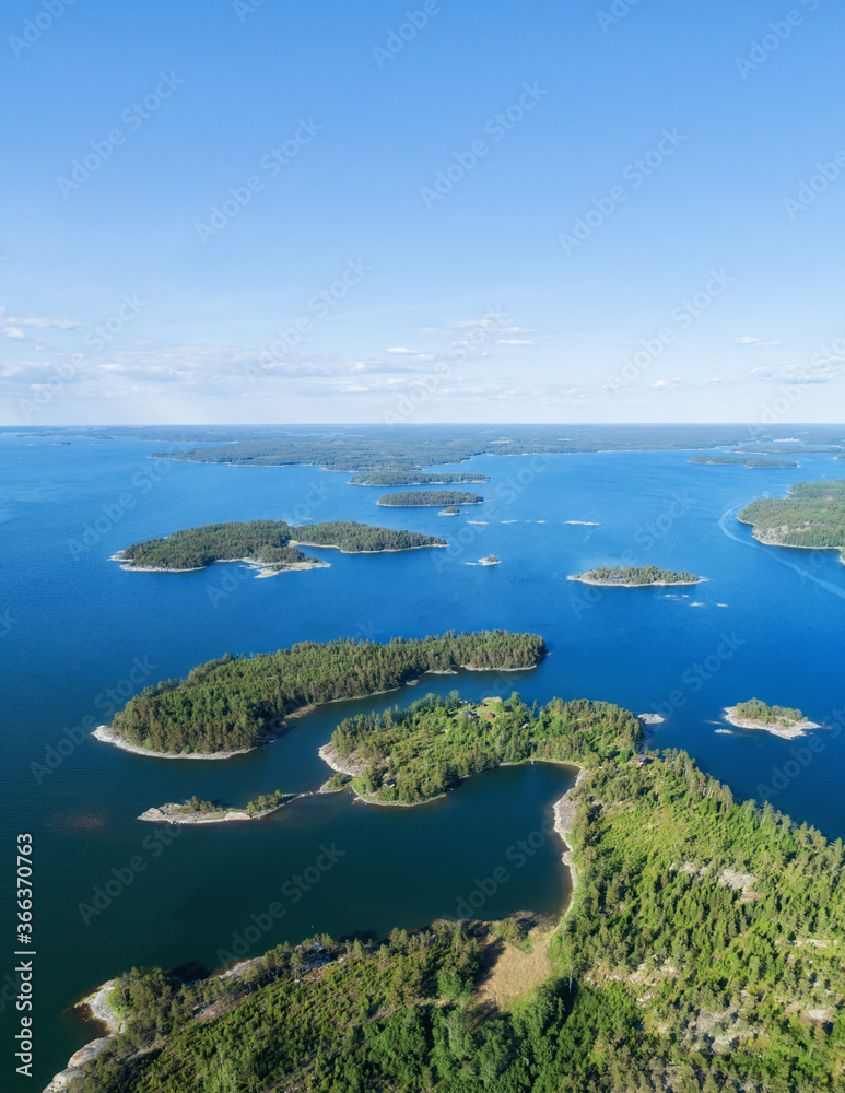 Aerial view of beautiful islands with green trees and rocks on the baltic sea at sunny summer day. Colorful landscape with islands. Top view. Saaristomeri, Finland.