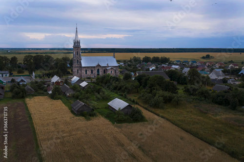 A beautiful  neo-Gothic church built of unusual stone in a small village. Eastern Europe . Aerial photography