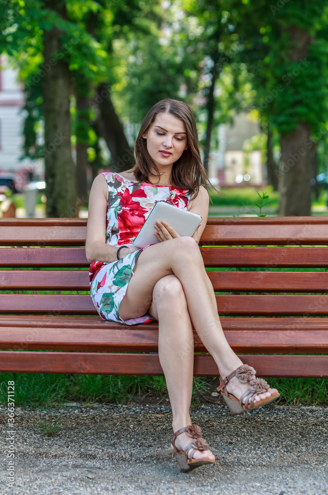 Young Woman with a Tablet in a Park Young Woman with a Tablet in a Park