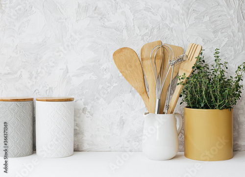 Kitchen utensils ceramic jar and thyme herb photo