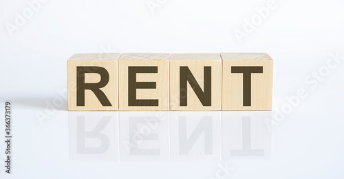 Wooden blocks with the word RENT. Preconception photo