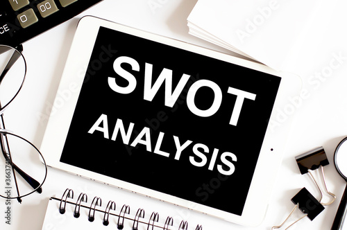 SWOT ANALYSIS Business Concept on white background with office tools