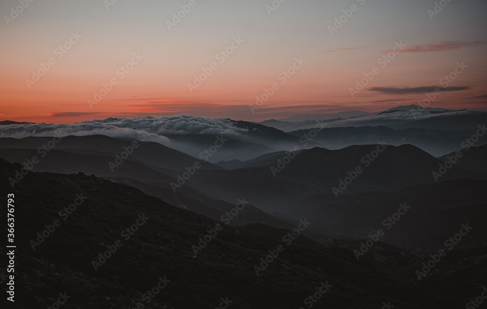 sunset in the mountains over the clouds