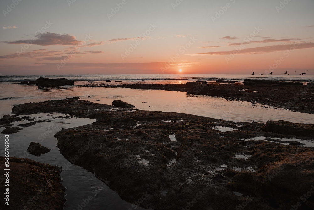sunset on the beach over tide pools sunset on the beach over tide pools