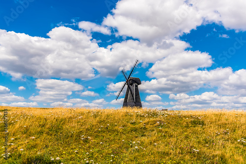 The view across Beacon Hill towards a windmill on the outskirts of Rottingdean, Sussex, UK in summer photo