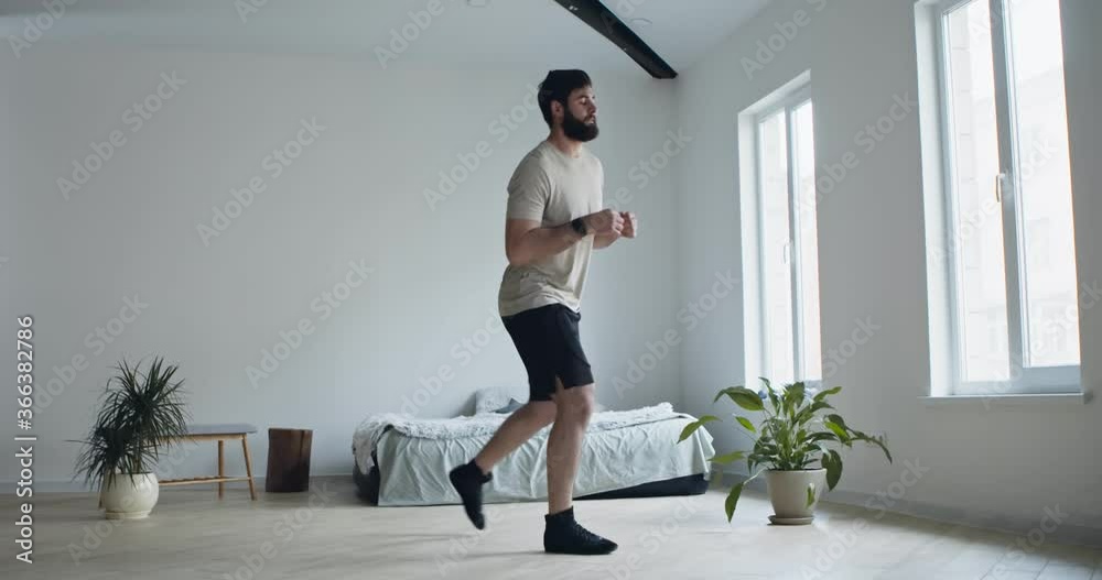 Bearded man doing lunges exercises for leg at home