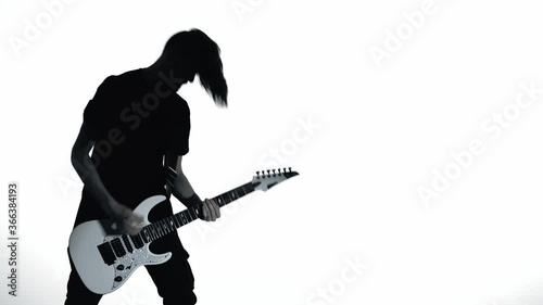 Silhouette of guitarist playing electric guitar