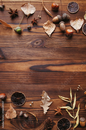 Autumn background, border made of dried leaves and acorns with copy space. Seasonal composition, fall, thanksgiving day concept. Flat lay, top view