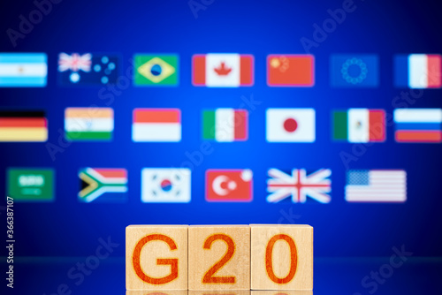 g20 concept. wooden blocks with the inscription g20 and the flags of the countries participating in the summit photo