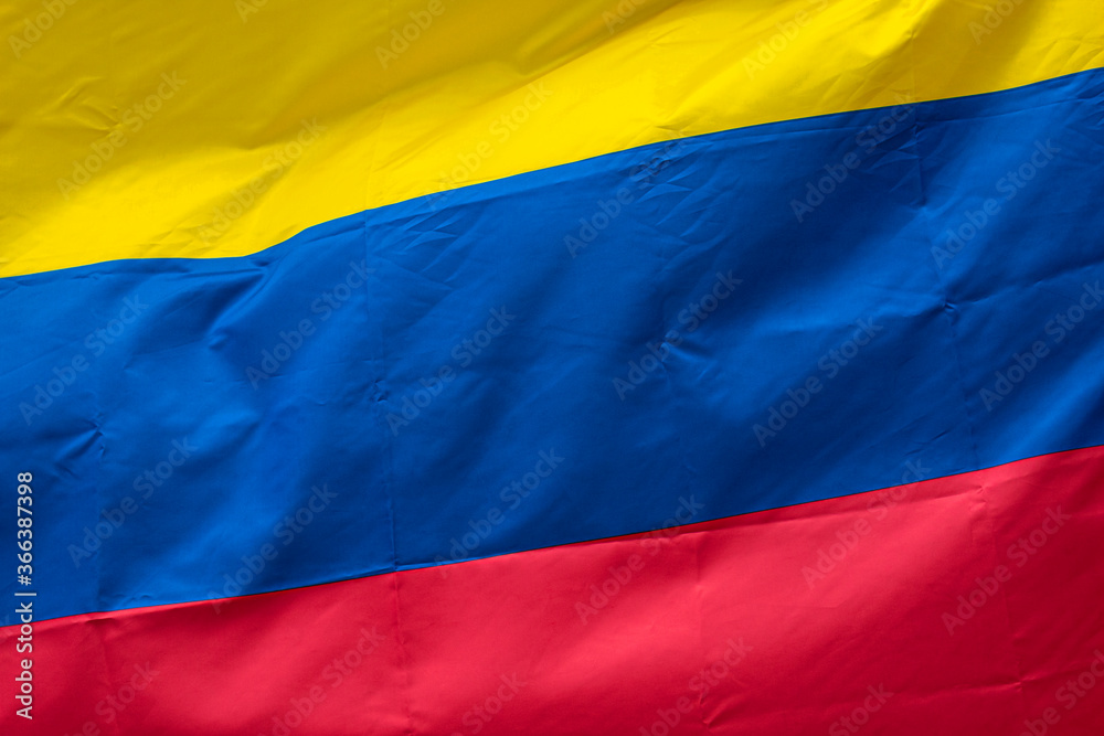 Naklejka premium Closeup to a Colombian flag waving with the wind. Nationality and country concept