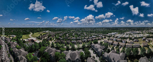 Canvas Print Puffy clouds on blue sunny sky above suburbs of a midwest city of Lexington Kent