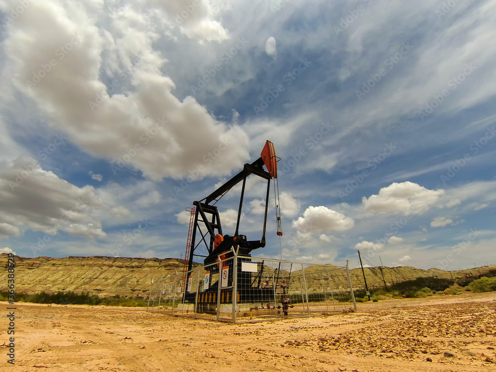 Naklejka premium Working oil pumps silhouette in row