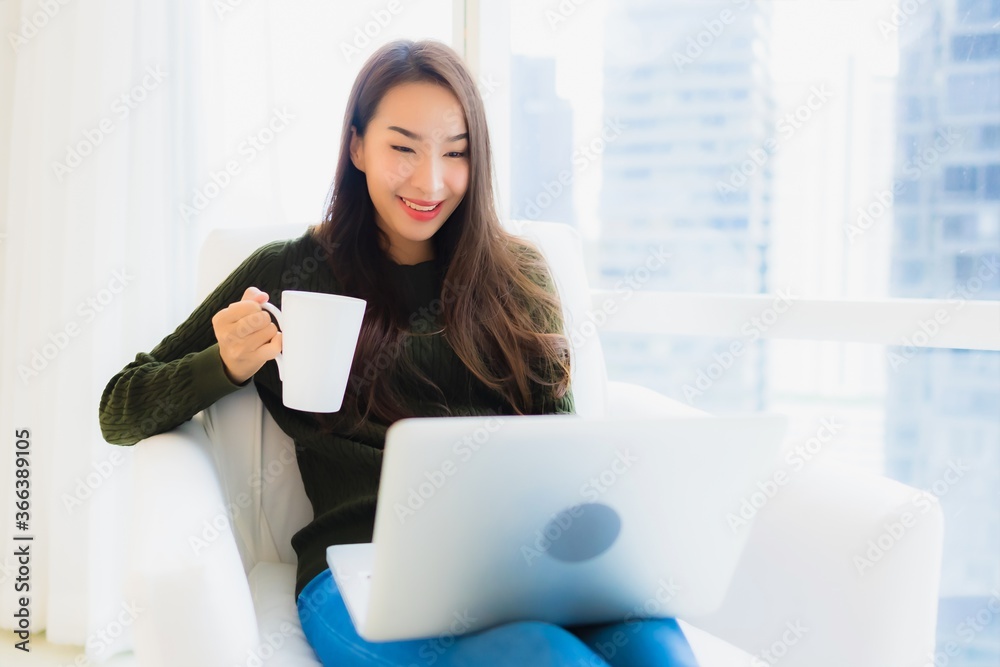 Portrait beautiful young asian woman with laptop and coffee cup on sofa Portrait beautiful young asian woman with laptop and coffee cup on sofa