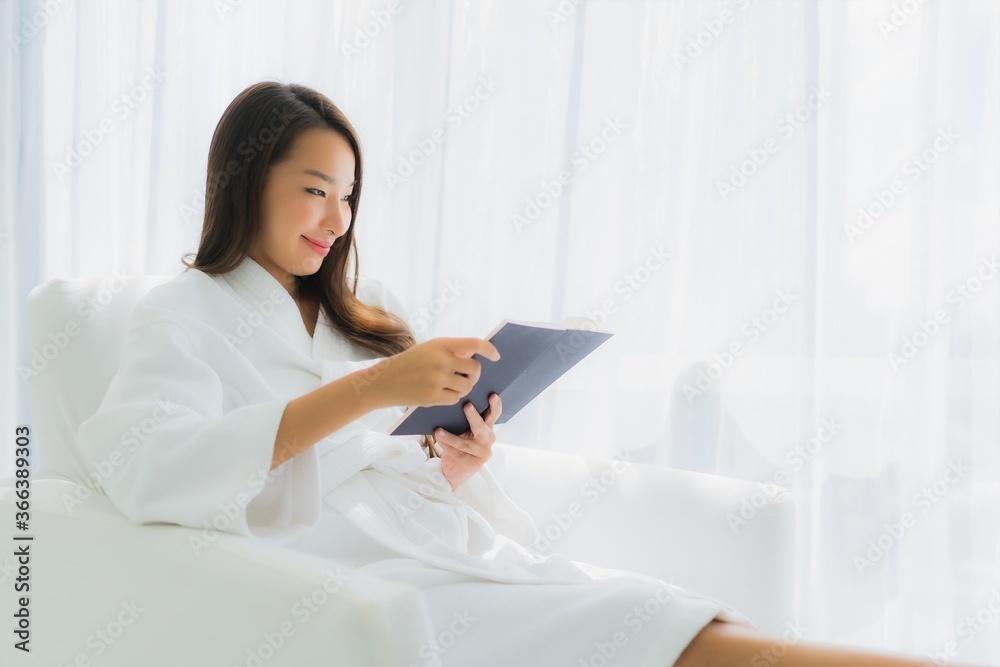 Portrait beautiful young asian woman reading book on sofa