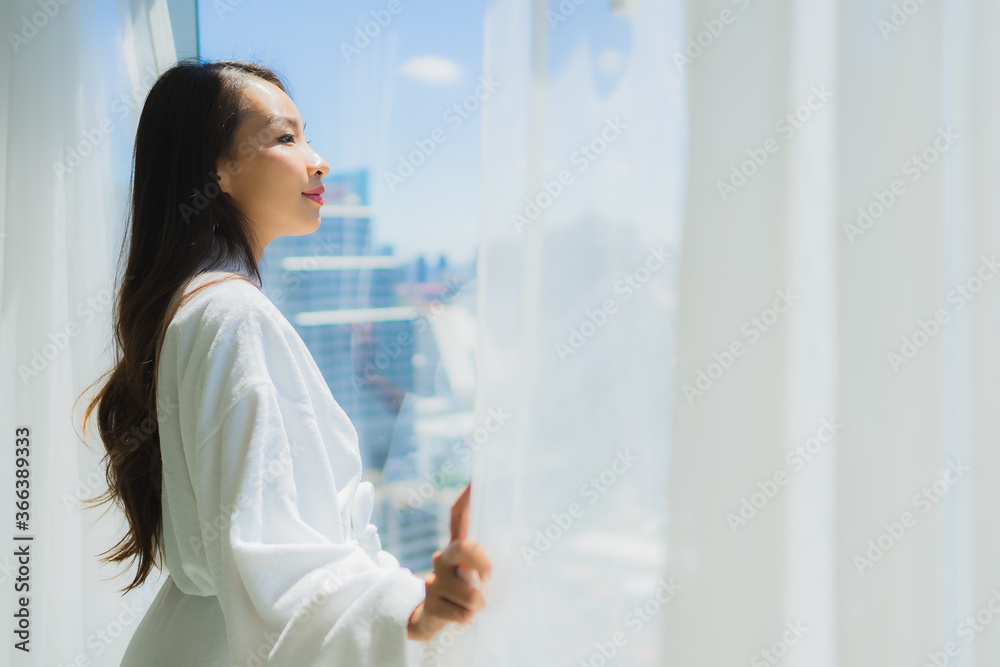 Portrait beautiful young asian woman look outside of window for the view