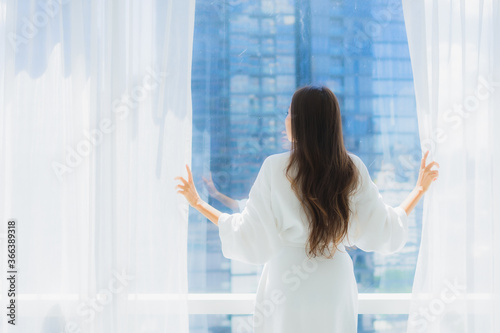 Portrait beautiful young asian woman look outside of window for the view Free Download Portrait beautiful young asian woman look outside of window for the view - GFXLoad