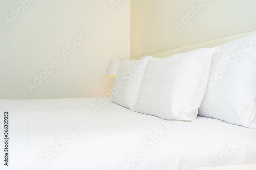 White comfortable pillow and blanket with light lamp