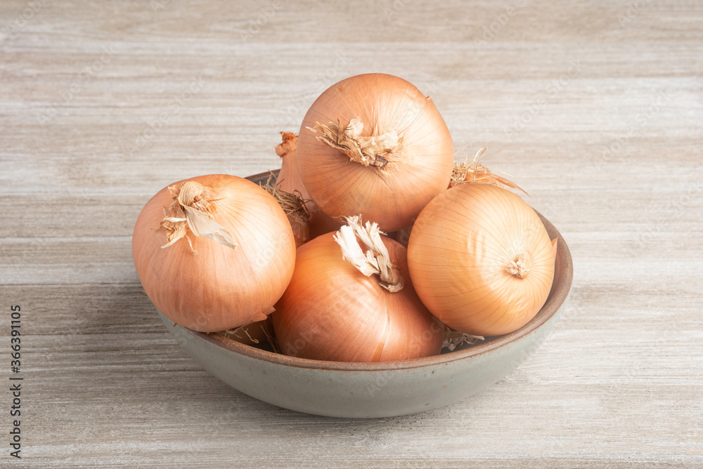 Sweet Southern-Grown Onions On A White Panel Board Sweet Southern-Grown Onions On A White Panel Board