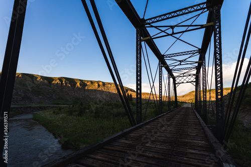 view of inside a metal bridge in summer on a sunset 