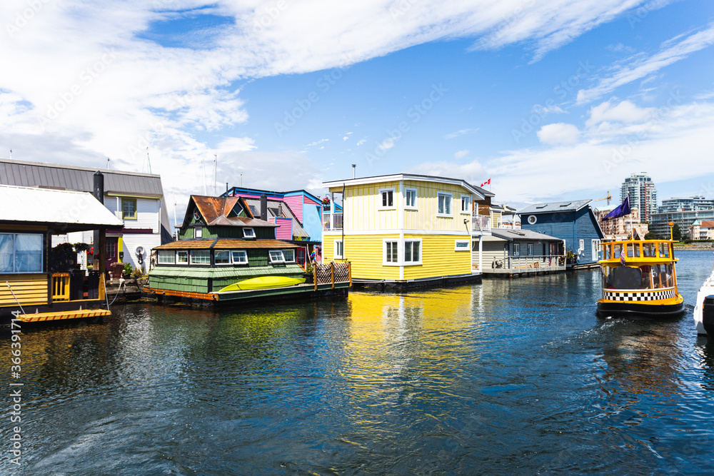 little colourful houses on the water on a sunny summer day