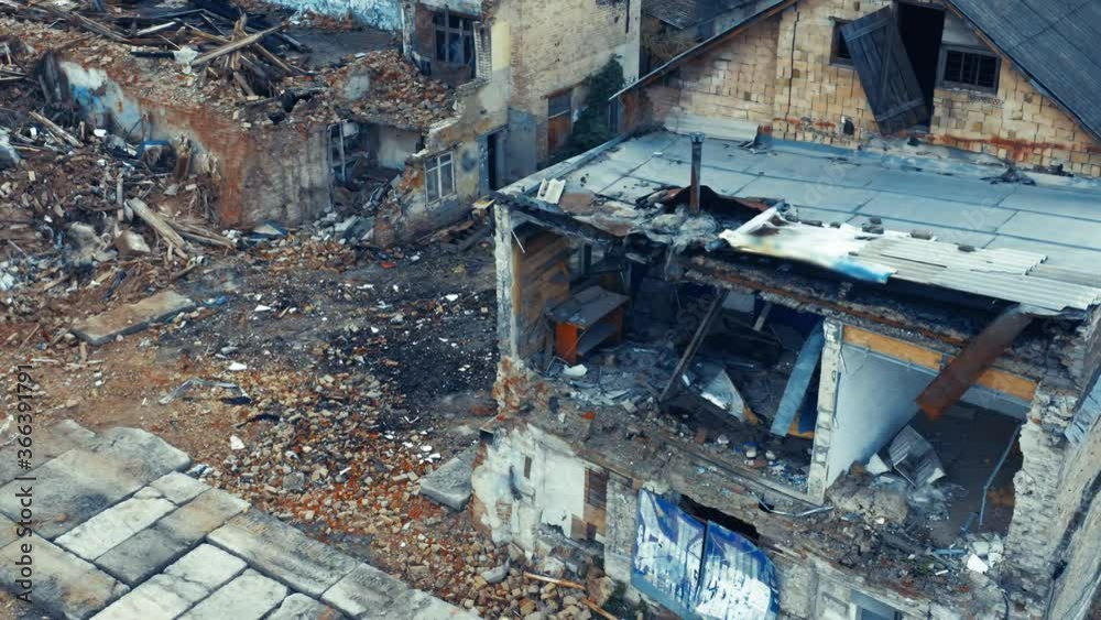 Abandoned ruins of a single-family home (detached house) on a deserted street. Aerial view