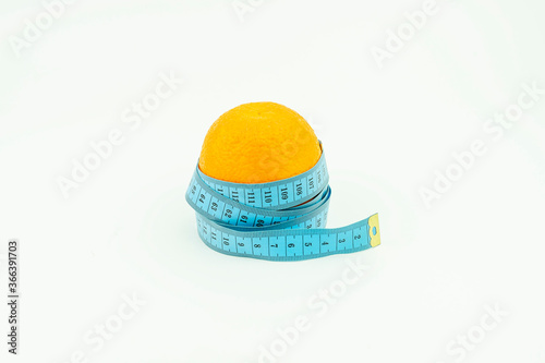 Orange wrapped in blue roulette. Fruit, Slimming, diet isolated on a white background.