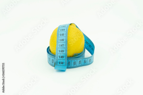lemon wrapped in blue roulette. Fruit, Slimming, diet isolated on a white background.