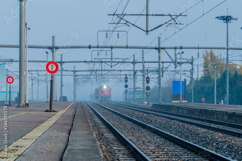 Train engine emerging from fog bank